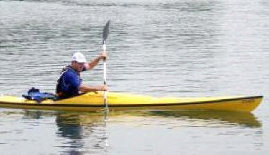 man paddling kayak